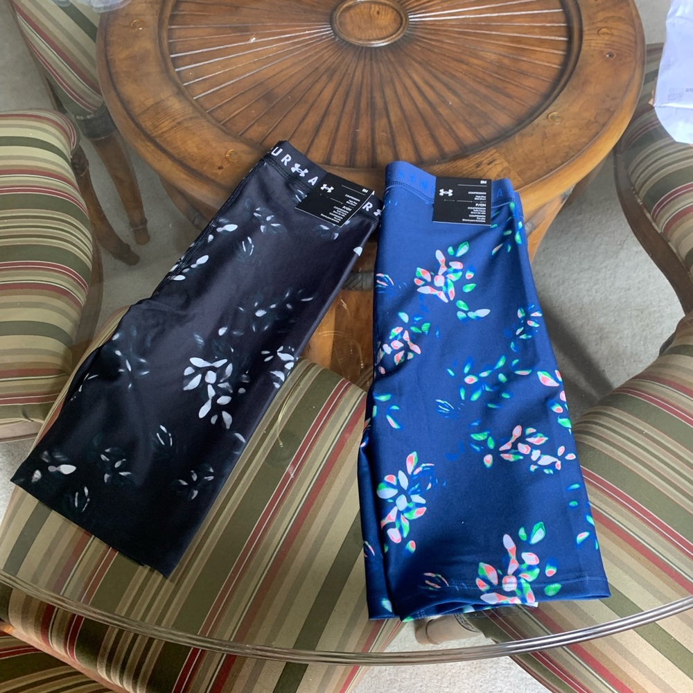 A set of Under Armor bike shorts .. one is navy the other is blue.